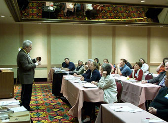Altschuler speaking at a professional conference.